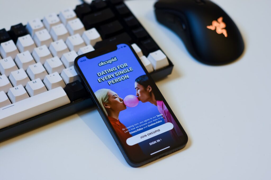 a cell phone sitting next to a computer keyboard